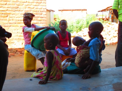 Kids in Nsanje take a break from their chores and sit in the shade at a local shop owned by a SACCO member